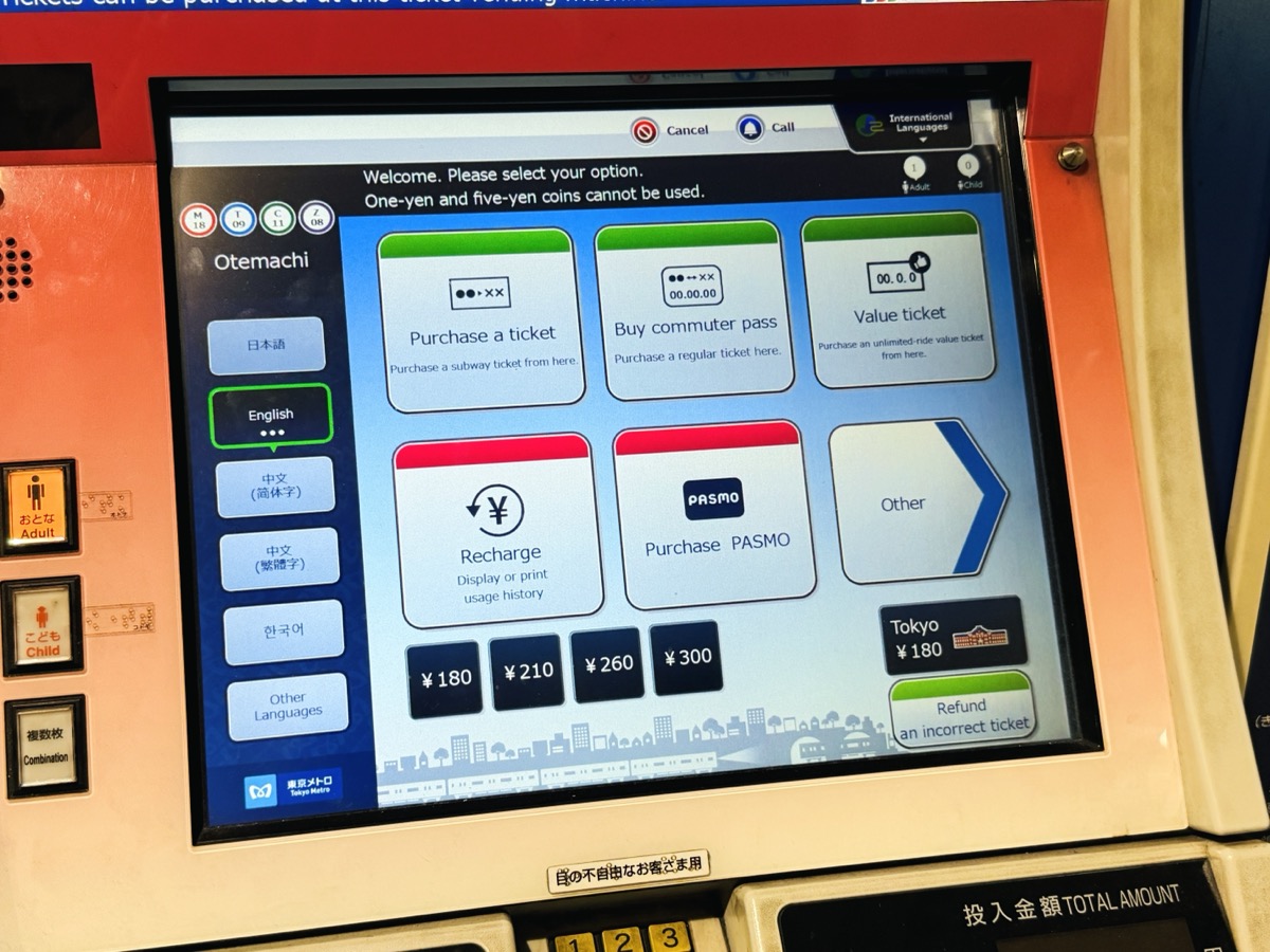 A Tokyo Metro ticket machine at Otemachi station in English mode, with menu buttons for Purchase a ticket, Buy commuter pass, Value ticket, Recharge, Purchase PASMO, and Refund an incorrect ticket